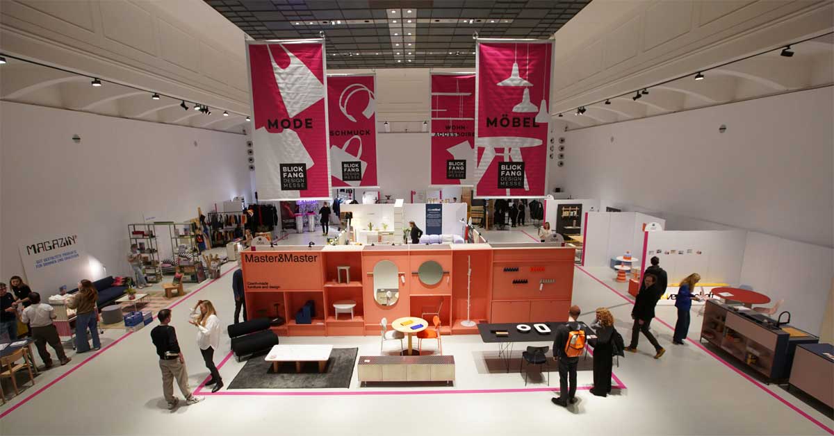 View of one exhibition hall at Blickfang Vienna 2024, part of the two-floor design fair at the MAK, showing curated booths and thematic banners. Photo: © Blickfang