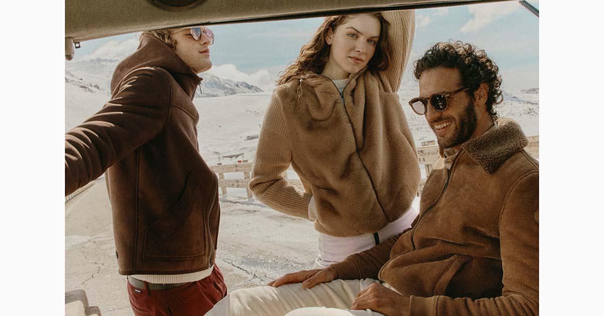 Colmar winter looks in brown tones against a snowy mountain backdrop.