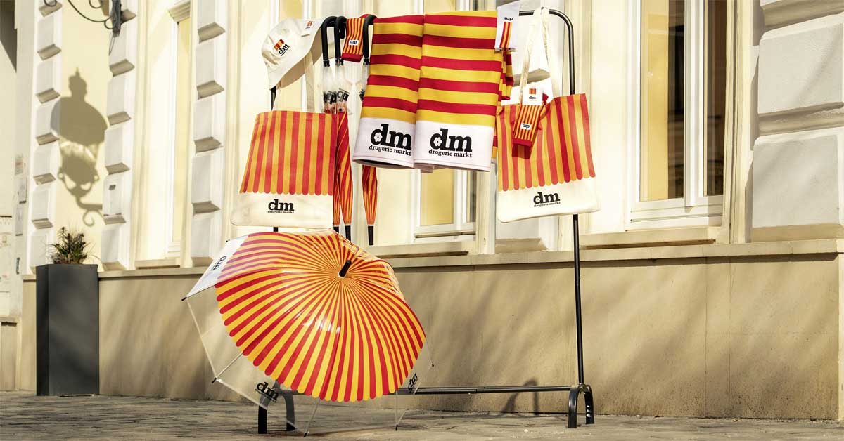 Vintage striped umbrella and accessories from the dm anniversary collection displayed outdoors