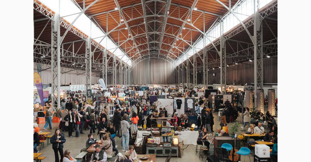 Edelstoff design market with visitors and exhibitor stands inside the Marx Halle in Vienna.