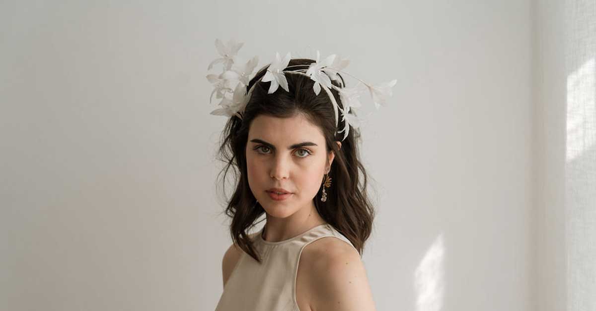 Handcrafted bridal hairband fascinator by Elisabeth Habig made of sinamay and feathers, wearable with or without a veil.