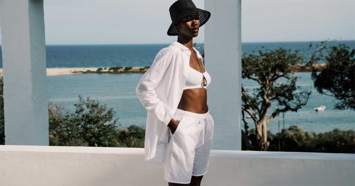 White minimalist daywear outfit by Hanro worn on a seaside terrace