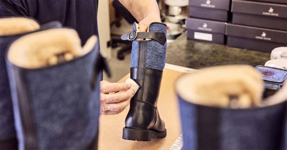 Craftsman finishing a Ludwig Reiter Maronibrater boot with denim shaft