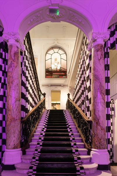 The image shows the elegant staircaise at the restaurant, bar art gallery 1o1 - One of One