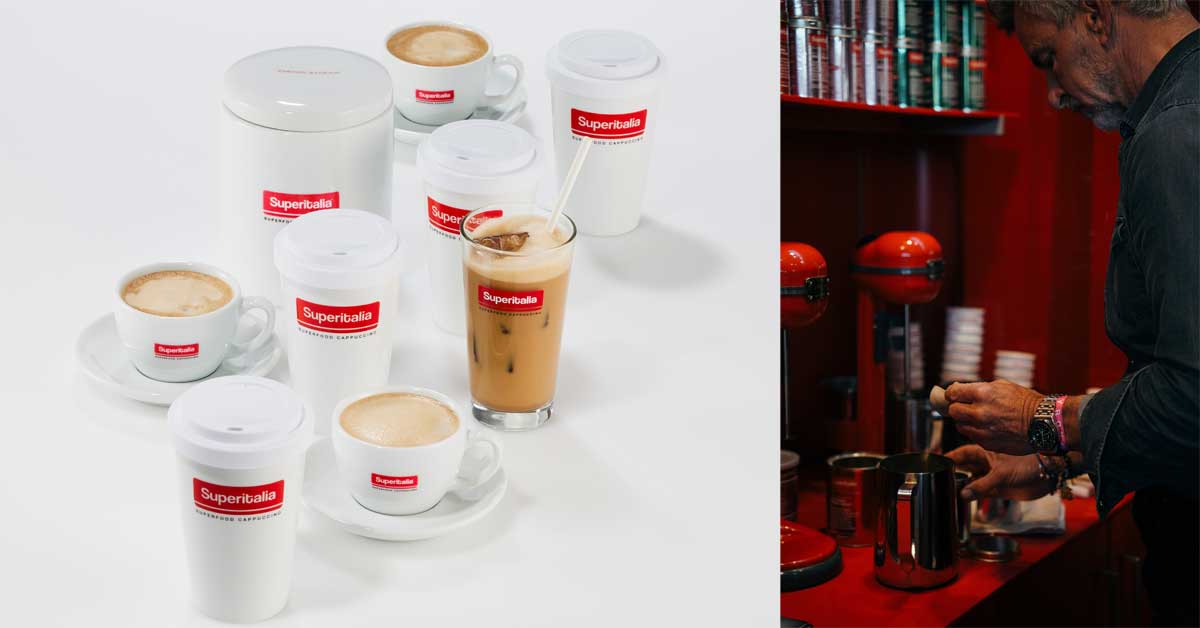 Cups and tumblers of Superitalia Superfood Cappuccino displayed on a white surface, alongside a barista preparing the coffee. Courtesy Superitalia.