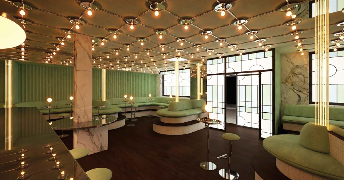 Interior of the new Sanatorium bar in Vienna with green seating, marble columns and warm globe lights.