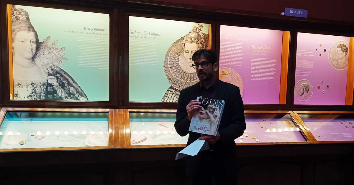 Director and co-curator holding the 'Coins in Fashion' magazine during a press tour at the Kunsthistorisches Museum Vienna, Coin Cabinet.