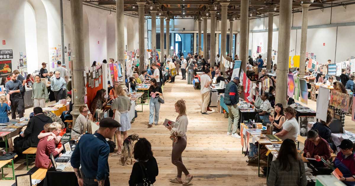 Fanzineist Vienna Art Book & Zine Fair at Semperdepot with visitors browsing tables of zines and publications in a previous year.