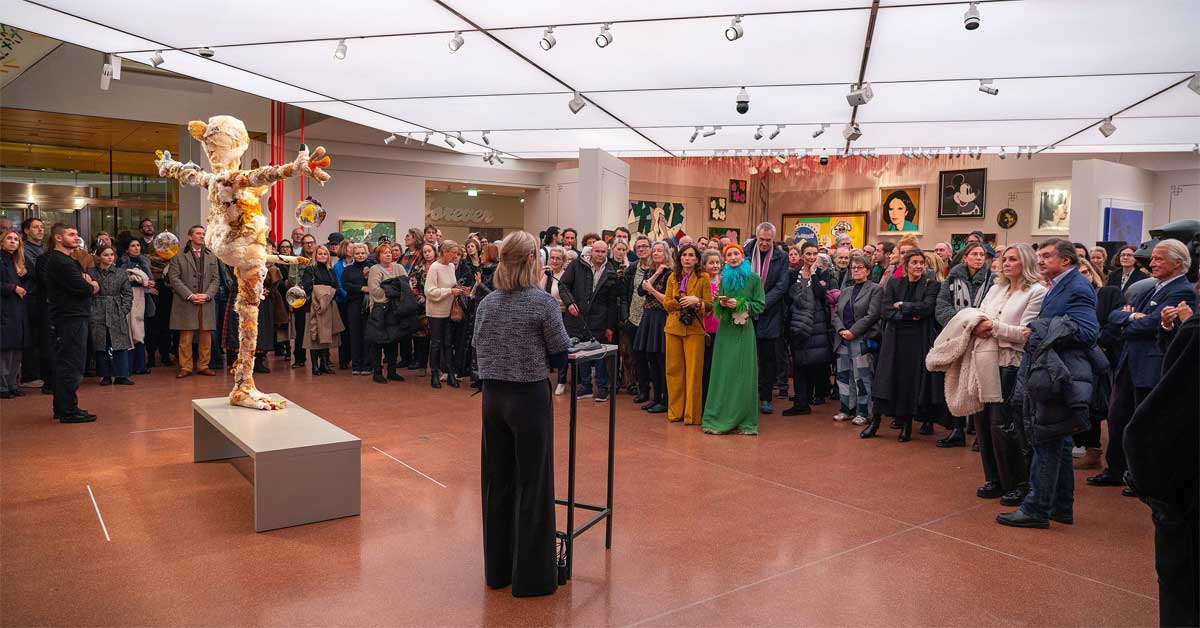 New director Verena Kaspar-Eisert speaks at the opening of Gelatin's Christmas installation at the Heidi Horten Collection, with the sculpture in the foreground.