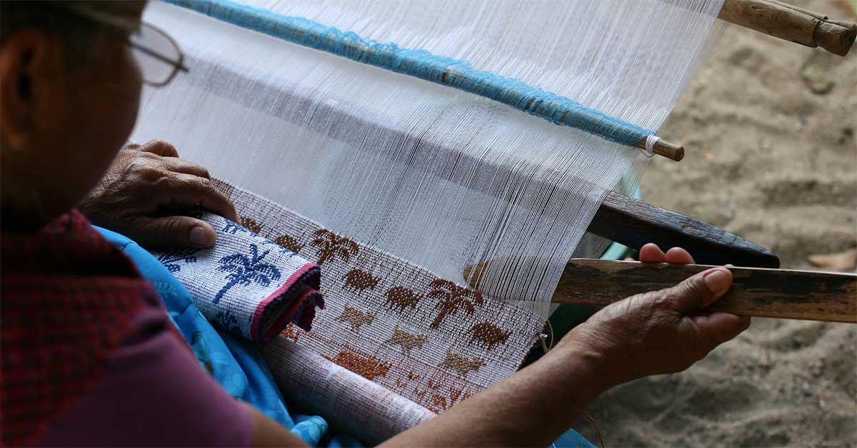 Weaver on backstrap loom creating traditional Mexican textile