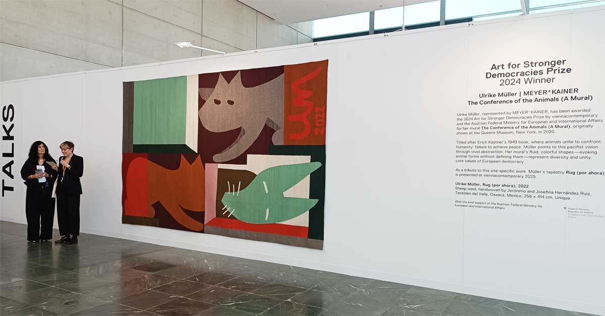 Abaseh Mirvali and Coraly von Welser speaking in front of Ulrike Müller’s tapestry during the Viennacontemporary 2025 press tour.