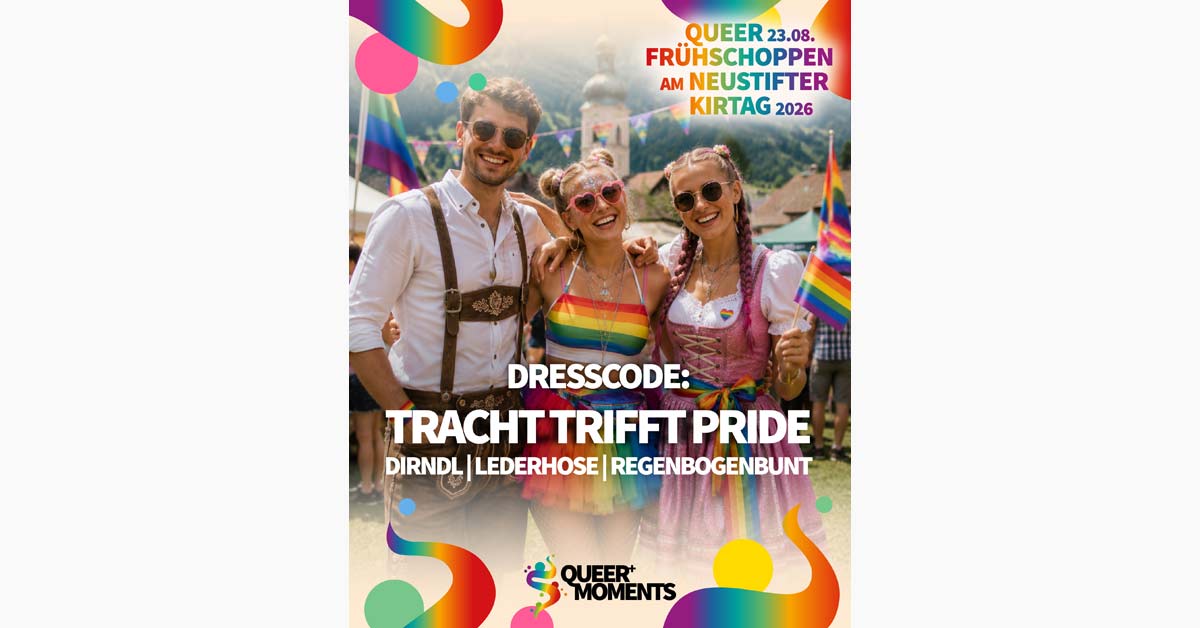 Three smiling visitors in colourful Tracht at a Pride-themed Neustifter Kirtag event, with rainbow flags and festival decorations.