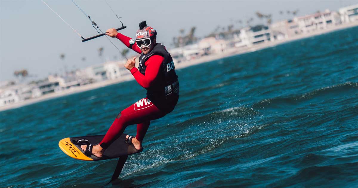 Valentin Bontus rides a hydrofoil kiteboard in a red wetsuit during training at Long Beach ahead of the LA28 Olympic test regatta.