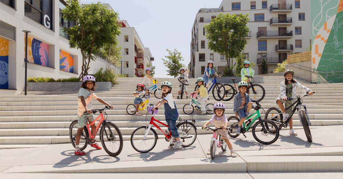 Children with bicycles in an urban neighbourhood.