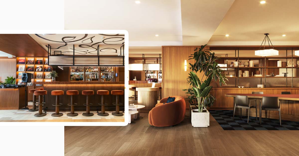 Interior of Poco Bar at Miiro Spittelberg with a long wooden counter, bar stools, drinks shelves and DJ equipment.